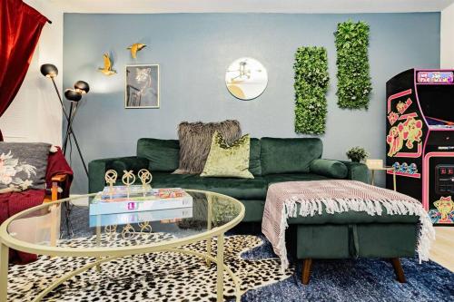 a living room with a green couch and a table at Star Motel Unit 1- Arts District Haven Modern Las Vegas Vacation Home in Las Vegas