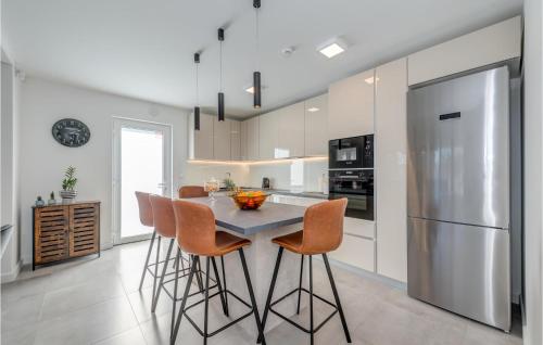 a kitchen with a table with chairs and a refrigerator at Stunning Home In Plano in Plano