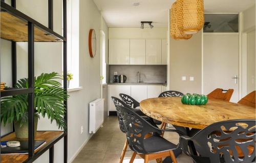 a kitchen and dining room with a table and chairs at Cozy Home In Vlagtwedde With Sauna in Vlagtwedde