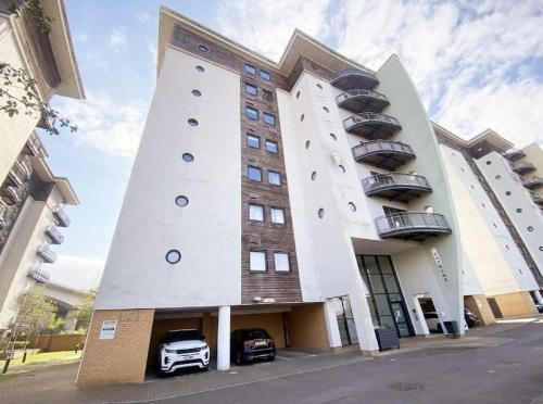a building with a car parked in front of it at Waterfront Apartment in Cardiff