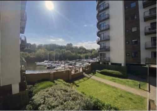 a view of a marina from a balcony of a building at Waterfront Apartment in Cardiff
