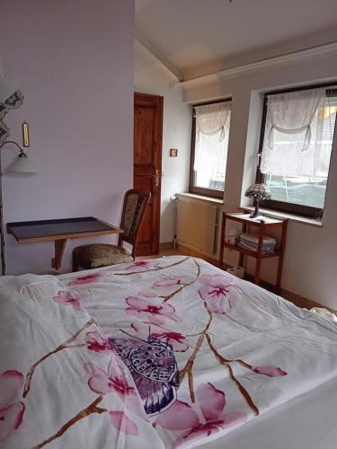 a bedroom with a bed with pink flowers on it at LDL-LUSIv in Bad Camberg