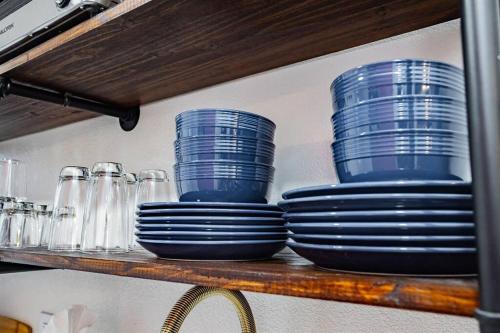 a shelf with blue plates and glasses on it at Star Motel Unit 2- Luxury Las Vegas Vacation Home Arts District Oasis in Las Vegas