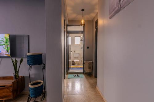 a hallway leading to a bathroom with a room with a hallway at Matinza Homes, Makerere - 10min Drive to KLA City in Kampala