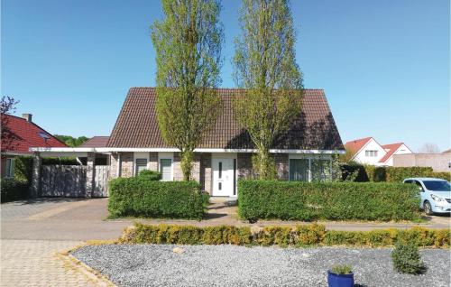 a house with two trees in a driveway at Pet Friendly Home In Zeewolde With Wifi in Zeewolde