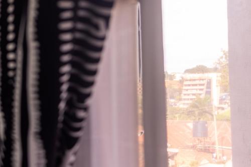 a window with a view of a city at Matinza Homes, Makerere - 10min Drive to KLA City in Kampala