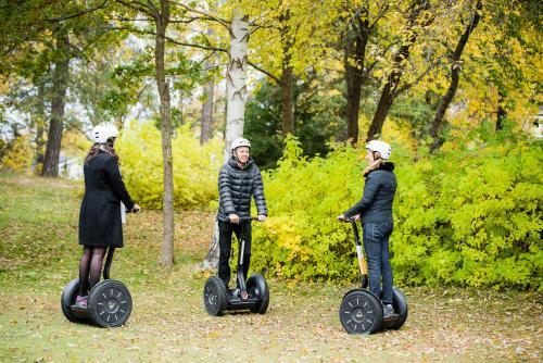 three people are riding segways in a park at Nynäsgården Hotell & Konferens in Nynäshamn