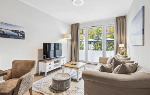 a living room with a couch and chairs and a tv at Baltischer Hof Apartment 19 in Boltenhagen