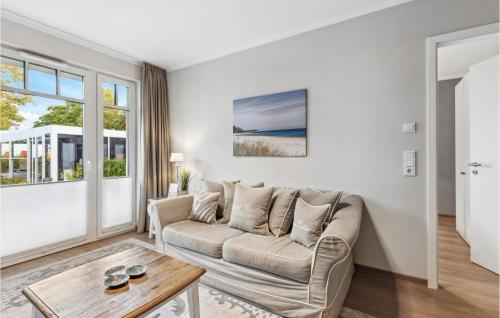 a living room with a couch and a table at Baltischer Hof Apartment 19 in Boltenhagen