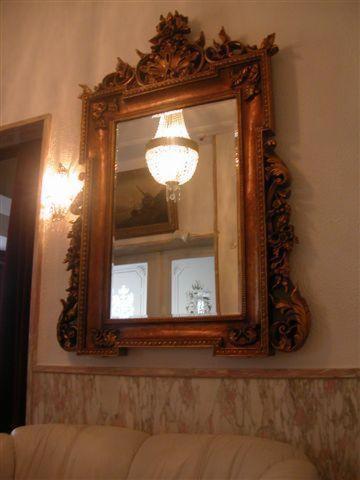 a mirror hanging on a wall with a couch at Rhein-Hotel in Andernach