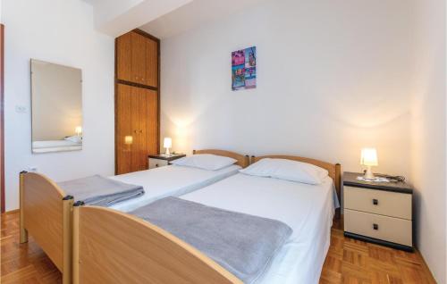 a bedroom with two beds and a mirror at Three-Bedroom Apartment In Plano in Plano