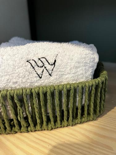 a close up of a green basket on a table at Widać Wydmy in Łeba