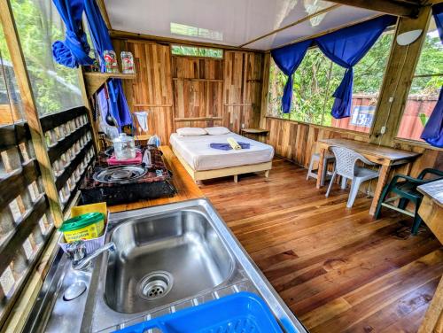 a kitchen with a sink and a bed in a rv at Arboura Eco Cabins in Uvita