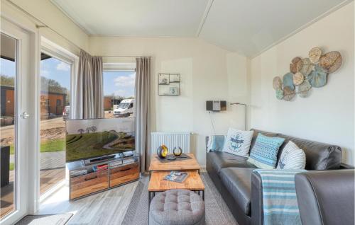 a living room with a couch and a tv at 2 Bedroom Amazing Home In Süsel in Süsel