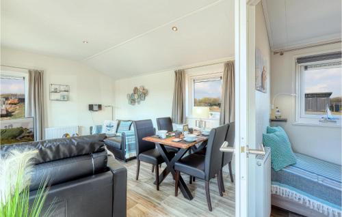 a living room with a couch and a table at 2 Bedroom Amazing Home In Süsel in Süsel