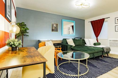 a living room with a green couch and a table at Star Motel Unit 4- Premier Downtown Hotel Luxury 1br Private Oasis in Las Vegas