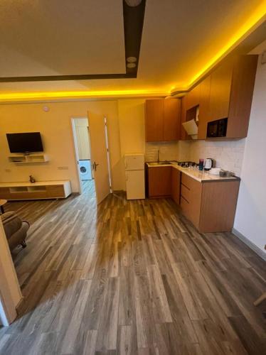 an empty kitchen and living room with wooden floors at My Sweet Home in Rustavi city 16 in Rustavi