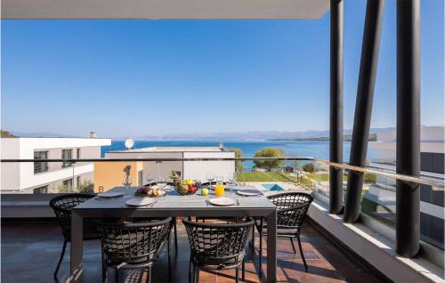 a table and chairs on a balcony with a view at Awesome Apartment In Zidarici With Wifi in Vantačići