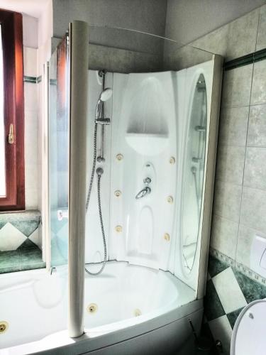 a bathroom with a shower and a bath tub at Ronf & Gnam GALIMBERTI in Turin