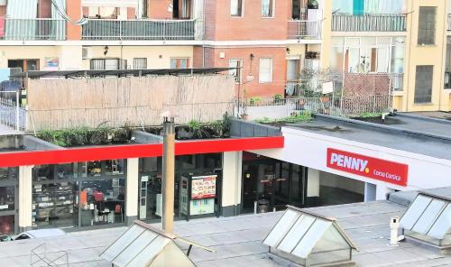 a view of a store with a red sign on the facade at Ronf & Gnam GALIMBERTI in Turin