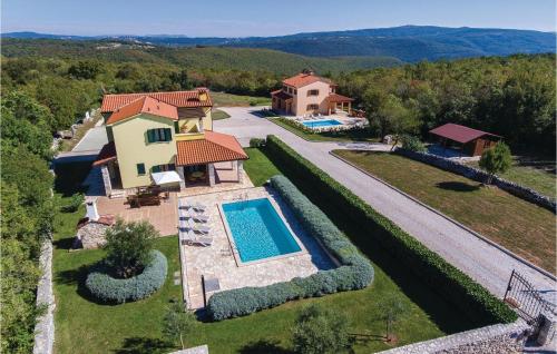 an aerial view of a house with a swimming pool at Holiday Home Kunj Croatia in Kunj