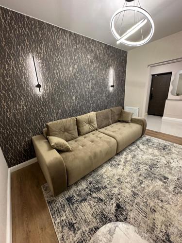 a couch in a living room with a wall at Apartments in center of Chisinau Anestiade in Chişinău