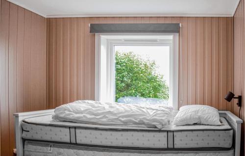 a bed in a room with a window at Cozy Home In Bjoa With Wifi in Utbjoa