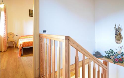 a wooden staircase in a room with a bed at Casa Giglio Rosso in Sovramonte