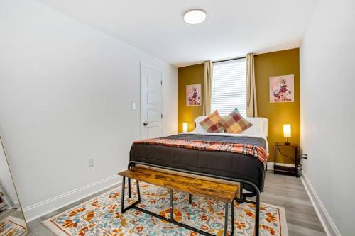 a bedroom with a bed and a table at Elegant 5-Bedroom NOLA Getaway in New Orleans