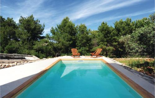 two chairs sitting next to a swimming pool at Amazing Home In Dragove in Dragove