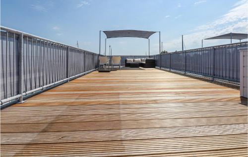 a wooden boardwalk on a building with a roof at Aqualiving in Aalsmeer
