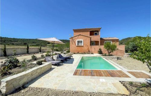a villa with a swimming pool and a house at Lovely Home In Cruzy With Kitchen in Cruzy