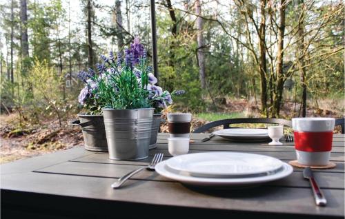 a table with plates and utensils and flowers on it at Vossenhol in Ommen