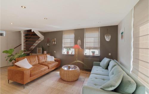 a living room with a couch and a table at Gorgeous Home In Wemeldinge With Wifi in Wemeldinge