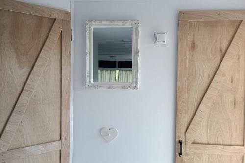a bathroom with a door and a mirror at Silvers Run in Zuidoostbeemster