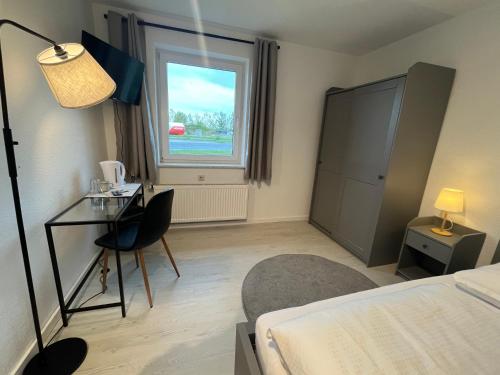 a room with a bed and a desk and a window at Truckcenter Fehrbellin an der A24 in Fehrbellin