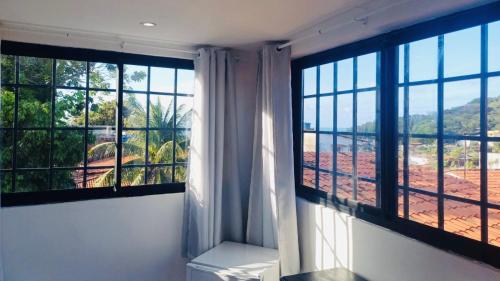 a room with a large window with a view at Residence Pipa Beach in Pipa