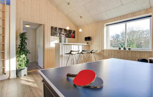 a kitchen with a red lid on a counter at 6 Bedroom Beautiful Home In Tranekær in Hou