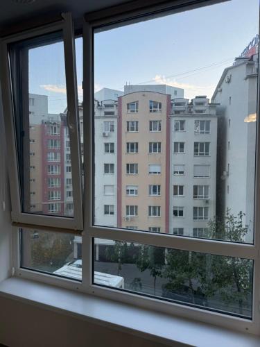 a window with a view of a building at Eva apartment in Chişinău