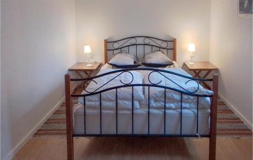 a bed in a room with two lamps on tables at 5 Bedroom Lovely Home In Tving in Tving