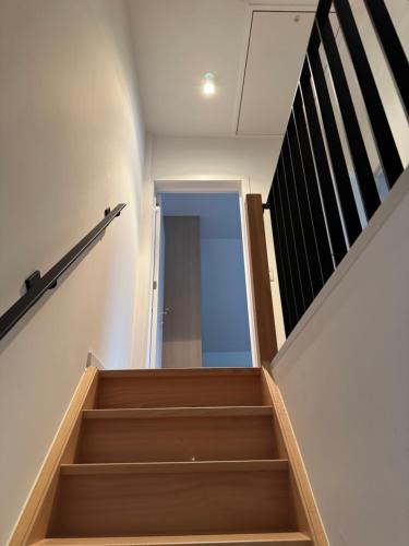 a staircase in a building with a stair case at koetshuis in Ypres