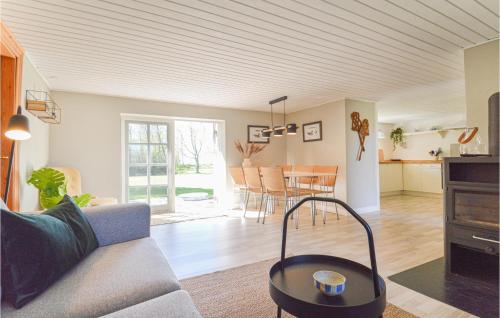 a living room with a couch and a table at Gorgeous Home In Askø With Kitchen in Askø