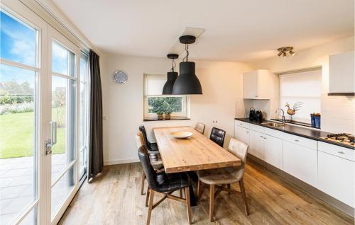 Una cocina y un comedor con mesa y sillas de madera. en Grote Wiedenwoning 6P, en Giethoorn