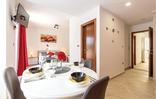 a dining room with a white table and chairs at One-Bedroom Apartment In Jesenice in Jesenice
