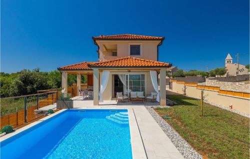 a villa with a swimming pool in front of a house at Villa Veduta in Pula