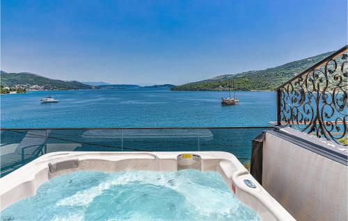 a hot tub on a balcony with a view of the water at 3 Bedroom Nice Apartment In Marina in Marina