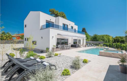 a villa with a swimming pool and a house at 4 Bedroom Beautiful Home In Banjole in Banjole