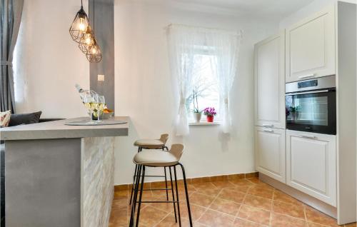 a kitchen with a counter and a bar with a stool at Amazing Home With Swiming Pool in Gačice