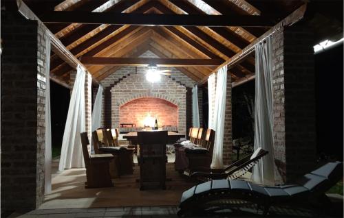 a patio at night with a table and chairs at Nice Home In Otocac With Sauna in Otočac