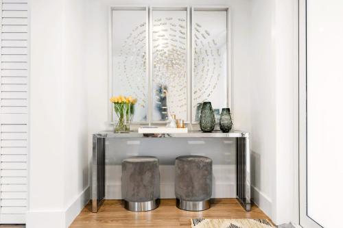 a console table with two stools in a room at Spectacular Miami 12 mil to Downtown 5Bedrooms Game Room Heated Pool in Tamiami